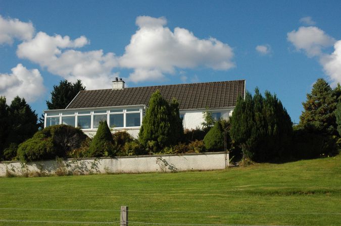 Strathardle is a large modern holiday bungalow situated in a quiet semi-rural position close to the centre of Lochcarron village in Wester Ross, Scottish Highlands.